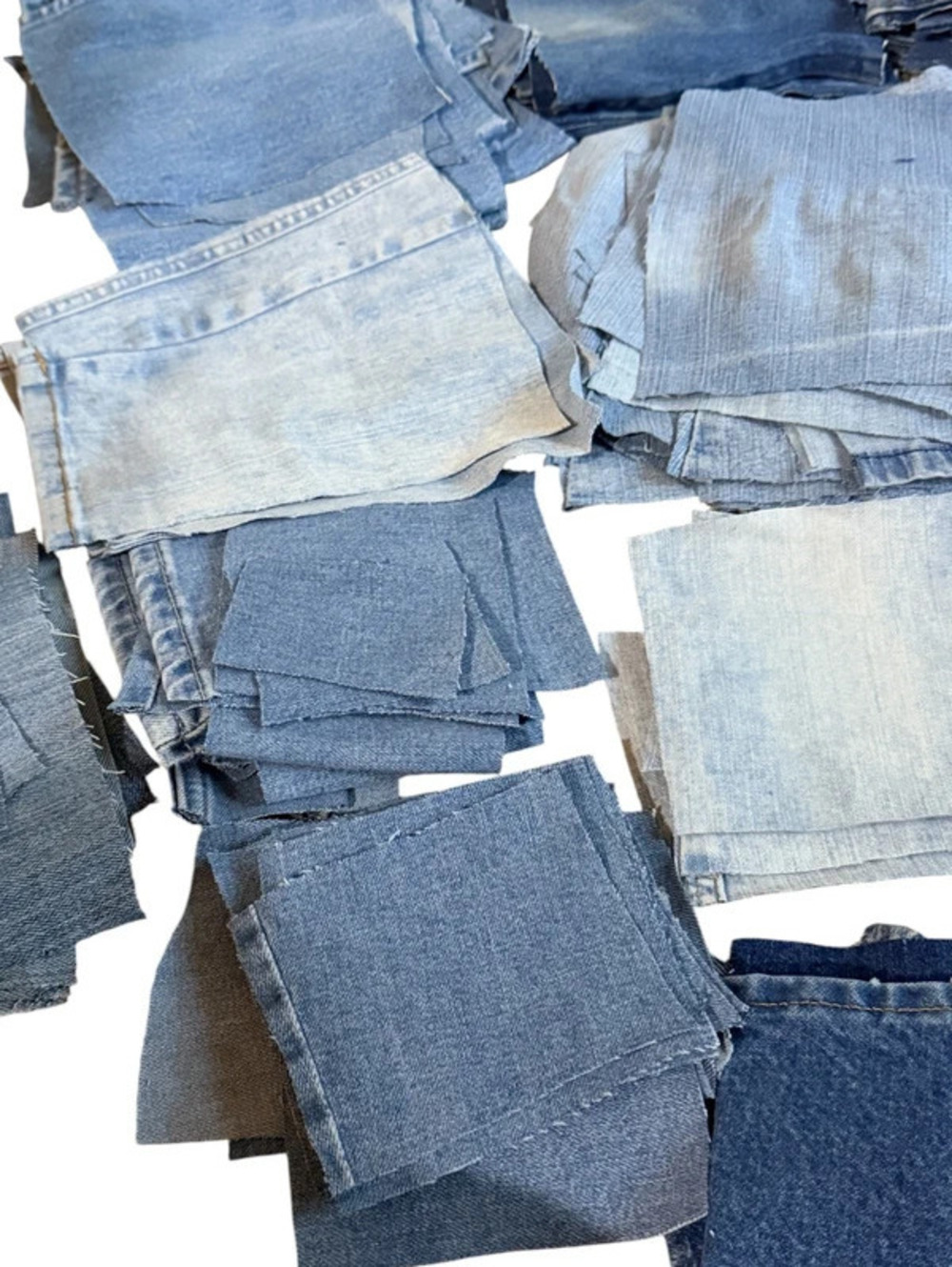 Bundle of cut denim squares all different wash colors